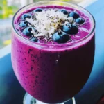 To make a tasty Blueberry Coconut Smoothie, you will need the following ingredients: - 1 cup fresh or frozen blueberries - 1 ripe banana - 1/2 cup coconut milk - 1/2 cup Greek yogurt or dairy-free alternative - 1 tablespoon honey or maple syrup - 1/4 cup unsweetened shredded coconut - 1 tablespoon chia seeds (optional) - Ice cubes (if using fresh blueberries) These ingredients work together to create a creamy and delicious treat. Blueberries offer sweetness and antioxidants. The banana adds creaminess and a natural sweetness. Coconut milk gives a tropical flavor, while Greek yogurt adds protein and a rich texture. Honey or maple syrup can sweeten it to your liking. Shredded coconut adds texture and flavor, and chia seeds boost nutrition. For a refreshing smoothie, use ice cubes if you choose fresh blueberries. Gather these ingredients, and you’re ready to blend your way to a delightful drink. Check out the Full Recipe for detailed instructions and tips! - Prepare the Blender Start by adding 1 cup of blueberries and 1 ripe banana into the blender. These fruits create a great base for your smoothie. - Add Creaminess Next, pour in 1/2 cup of coconut milk and 1/2 cup of Greek yogurt. This mix gives your smoothie a rich and creamy texture. - Sweeten Your Smoothie Drizzle in 1 tablespoon of honey or maple syrup. Adjust the sweetness to your taste. You can always add more later! - Incorporate Coconut and Chia Toss in 1/4 cup of shredded coconut and 1 tablespoon of chia seeds, if you want. This adds nice texture and nutrition. - Ice for Chill If you are using fresh blueberries, add a handful of ice cubes. This keeps your smoothie refreshingly cool. - Blend Secure the lid on the blender and blend on high until smooth. Stop to scrape down the sides if needed. - Taste Test After blending, taste your smoothie. If it needs more sweetness, add more honey or syrup and blend again. - Serve Pour your smoothie into a glass. Sprinkle extra shredded coconut on top for a lovely finish. Feel free to check the Full Recipe for more details! How to Achieve Creaminess To get a smooth and creamy texture, use ripe bananas. They add natural sweetness and creaminess. Combine them with coconut milk and Greek yogurt. These ingredients work together to create a rich base. If you find your smoothie too thick, add a bit more coconut milk to loosen it. Adjusting Sweetness Taste your smoothie after blending. If it isn’t sweet enough, add more honey or maple syrup. Start with a small amount, then blend again. This allows you to control the sweetness level. Everyone's taste is different, so you can make it just right for you. Maintaining Chill Factor Keep your smoothie cold and refreshing. If you use fresh blueberries, toss in some ice cubes. This will help chill the drink fast. You can also freeze some banana slices ahead of time. This adds both chill and creaminess to your smoothie. Presentation Tips Serve your smoothie in clear glasses. This showcases the vibrant colors of the blueberries and coconut. For a fun touch, add a colorful straw or a slice of banana on the rim. It makes your smoothie look even more inviting. Garnishing Ideas Garnish with extra shredded coconut or a few fresh blueberries on top. You can also sprinkle some chia seeds for a nice crunch. This adds texture and makes the drink look appealing. Enjoy your beautiful smoothie! {{image_4}} Dairy-free Options You can easily swap Greek yogurt for a dairy-free yogurt. Look for options made from almond, coconut, or soy. These will keep the smoothie creamy without dairy. For the coconut milk, you can also use oat milk or almond milk for a lighter taste. Using Alternative Sweeteners If you want less sugar, try using dates or agave syrup instead of honey or maple syrup. These natural sweeteners add a nice flavor while cutting back on processed sugars. Just remember to blend them well to mix into the smoothie. Other Fruits or Add-ins Feel free to mix in other fruits like strawberries, mangoes, or peaches. They all pair well with blueberries. You can also add spinach or kale for extra nutrition. Just a small handful will keep your smoothie vibrant and tasty. Summer Refreshments In summer, add some fresh mint leaves for a cooling twist. You can also freeze your smoothie in popsicle molds for a fun treat. This makes a great snack on hot days, keeping you cool and refreshed. Winter Comfort Smoothies For winter, consider adding spices like cinnamon or nutmeg. They give a warm flavor that feels cozy. You can also blend in some cooked sweet potato for added creaminess and nutrition. This version is perfect for those chilly mornings. Blueberries' Antioxidant Properties Blueberries are packed with antioxidants. These help fight free radicals in your body. They may reduce the risk of heart disease. Blueberries also support brain health and improve memory. Coconut and Its Nutritional Value Coconut is rich in healthy fats. It provides quick energy and may boost metabolism. Coconut also contains fiber, which aids digestion. The natural sweetness of coconut makes smoothies taste great, too. Benefits of Greek Yogurt Greek yogurt is a fantastic source of protein. It helps build muscle and keep you full. This yogurt also has probiotics, which support gut health. Plus, it adds creaminess to your smoothie. Calories per Serving Each serving of this smoothie has about 250 calories. This number can change based on your ingredients. For a lighter option, adjust the yogurt or sweetener. Macronutrient Overview - Carbohydrates: Around 40 grams - Protein: About 10 grams - Fat: Roughly 8 grams This smoothie is a balanced choice for breakfast or a snack. You can feel good about enjoying it! For the full recipe, check out the [Full Recipe]. Can I make this smoothie ahead of time? Yes, you can make this smoothie ahead of time. Just blend it and store it in the fridge. It stays fresh for up to 24 hours. But, it tastes best when fresh. Can I freeze leftovers? You can freeze leftovers for later use. Pour the smoothie into ice cube trays or freezer-safe bags. This way, you can enjoy it later. Just blend the cubes into a fresh smoothie. What can I add for extra protein? You can add a scoop of protein powder or nut butter for extra protein. Greek yogurt also adds protein while keeping it creamy. Is this smoothie vegan-friendly? Yes, you can make this smoothie vegan-friendly. Use a dairy-free yogurt and maple syrup instead of honey. How long does it take to prepare? It takes about 10 minutes to prepare this smoothie. You can enjoy it quickly, making it a great choice for busy mornings. This smoothie combines fresh blueberries, bananas, and coconut milk for a tasty treat. You learned how to prepare it step by step. I also shared tips for perfect texture and how to serve it nicely. You can make variations based on what you have at home or the season. The ingredients offer health benefits that make this smoothie not only delicious but good for you. Enjoy making it, and feel free to experiment!