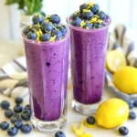 To make a Blueberry Lemon Yogurt Smoothie, gather these items: - 1 cup fresh or frozen blueberries - 1 ripe banana - 1 cup plain Greek yogurt - 1 tablespoon honey (or adjust to taste) - 1 tablespoon freshly squeezed lemon juice - ½ cup almond milk (or your preferred milk) - Zest of 1 lemon - A handful of ice cubes (optional) These ingredients work together to create a tasty and healthy drink. The blueberries add sweetness and color. The banana gives a creamy texture. Greek yogurt adds protein and richness. Lemon juice and zest provide a bright, zesty flavor. You can make your smoothie look fancy with these garnishes: - Whole blueberries - A light sprinkle of lemon zest - Lemon slices on the rim of the glass These simple touches not only add beauty but also enhance the flavor. They make your drink more fun to enjoy. If you don't have some ingredients, here are good substitutes: - Use regular yogurt instead of Greek yogurt. - Swap almond milk for any milk you like. - Try maple syrup or agave instead of honey. - Use other fruits, like strawberries or peaches, for a twist. These substitutes can change the taste but still keep the smoothie delicious. Feel free to mix and match based on what you have at home! {{ingredient_image_2}} Start by preparing your ingredients. If you use fresh blueberries, rinse them well under cold water. This step keeps your smoothie clean and fresh. If you choose frozen blueberries, skip the washing. They are ready to blend straight from the freezer. Next, grab a ripe banana. This adds natural sweetness and creaminess to your smoothie. Now it’s time to blend! In your blender, combine the blueberries, banana, Greek yogurt, honey, lemon juice, almond milk, and lemon zest. Ensure all ingredients are in the blender to create a smooth mix. Blend on high speed. Watch as the colors mix and transform into a creamy delight. If you want a thicker smoothie, toss in a handful of ice cubes and blend again. After blending, taste your smoothie. If it needs more sweetness, add a bit more honey and blend once more. You want the perfect balance of flavors. Pour your smoothie into tall glasses. For a pretty touch, garnish with whole blueberries and a sprinkle of lemon zest. This not only looks great but adds extra flavor. Enjoy your delicious blueberry lemon yogurt smoothie! To make the best smoothie, start with ripe, fresh ingredients. Use ripe bananas for natural sweetness. Always wash fresh blueberries well. If using frozen blueberries, no washing is needed. This keeps the flavor intact. Use plain Greek yogurt for creaminess and protein. Measure your liquids and solids for a balanced mix. Blend at high speed for a smooth texture. Add a bit more lemon juice for a zesty kick. You can also try vanilla extract for extra flavor depth. If you like a sweeter taste, mix in more honey. A pinch of salt can elevate the overall flavor too. Consider adding fresh mint leaves for a refreshing twist. You can even toss in a handful of spinach for extra nutrients without changing the taste. Don’t skip the banana; it gives the smoothie body. Avoid over-blending, as it can make the smoothie too thin. If your smoothie is too thick, add more milk gradually. Be careful not to add too much honey; sweetness can quickly overpower. Lastly, remember to taste it before serving. You might want to adjust sweetness or tartness then! Pro Tips Use Frozen Blueberries: They not only chill the smoothie but also enhance the creaminess without the need for ice. Adjust Sweetness to Taste: Depending on the ripeness of your banana and your personal preference, feel free to add more or less honey. Try Different Yogurts: For a lighter option, you can substitute Greek yogurt with a dairy-free yogurt or a low-fat alternative. Add Protein: Boost the nutritional value by incorporating a scoop of your favorite protein powder into the blend. {{image_4}} You can swap or add fruits to your blueberry lemon yogurt smoothie. Here are some tasty options: - Strawberries - Raspberries - Mangoes - Pineapple - Peaches These fruits can give your smoothie a new flavor. Each fruit adds its unique charm. For example, mango adds a creamy texture, while raspberries bring a nice tartness. If you want a dairy-free smoothie, use non-dairy yogurt. Options include: - Almond yogurt - Coconut yogurt - Soy yogurt You can also switch Greek yogurt for a nut milk, like almond or oat milk. Just make sure to keep the same liquid amount to maintain the smoothie’s texture. Want to make your smoothie more filling? Add protein! Here are some easy ideas: - A scoop of protein powder - Chia seeds - Flaxseeds - Nut butter Nut butter adds a creamy richness. Chia seeds boost fiber and protein. Just one tablespoon of these ingredients can greatly enhance the smoothie without changing its great taste. You can store any leftover smoothie in the fridge. Use an airtight container. It will stay fresh for up to 24 hours. When you are ready to drink it, give it a good shake. The ingredients may separate, but that’s normal. If you want to prepare ahead, freeze the ingredients. Portion the blueberries, banana, and lemon zest into freezer bags. Store them flat for easy stacking. When you’re ready, just blend them straight from the freezer. This keeps your smoothie ready without waste. Smoothies are best enjoyed cold, so reheating isn’t needed. If you froze your smoothie, thaw it overnight in the fridge. You can also leave it out for a couple of hours. After thawing, blend it again for a smooth texture. Enjoy! Yes, you can use frozen blueberries. They make the smoothie cold and thick. Just toss them in the blender without thawing. It is an easy swap and saves time. To sweeten your smoothie, add more honey. Start with one tablespoon. Then blend and taste. If you want it sweeter, keep adding a little at a time. This smoothie is packed with nutrients. Blueberries are full of antioxidants. They help fight free radicals. Greek yogurt gives you protein and probiotics for gut health. Lemon juice adds vitamin C, which boosts your immune system. Yes, you can prepare the smoothie in advance. Blend all the ingredients, then store it in the fridge. However, for the best taste and texture, drink it within 24 hours. If you freeze it, it can last for a week. Just blend it again when you’re ready to enjoy! In this post, we covered the key ingredients, step-by-step instructions, and helpful tips for making a perfect blueberry lemon yogurt smoothie. We explored different variations, proper storage methods, and answered common questions. You now have all the tools to create a tasty and healthy drink. Experiment with flavors and find what you love. Smoothies can be fun and good for you, so enjoy every blend!