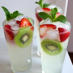 Gathering fresh ingredients is key to a tasty Strawberry Kiwi Limeade. Here&rsquo;s what you need: - Strawberries: 1 cup, hulled and halved - Kiwis: 2 ripe, peeled and sliced - Lime Juice: 1/2 cup (freshly squeezed, approx. 4-5 limes) - Sweetener: 1/4 cup honey or agave syrup - Sparkling Water: 4 cups, chilled - Ice Cubes: for serving - Garnish: Fresh mint leaves Using ripe strawberries and kiwis will give your drink a bright, fresh taste. Look for strawberries that are vibrant red and firm. For kiwis, choose ones that yield slightly to pressure. Fresh lime juice adds a sharp tang that balances the sweetness. Adjust the honey or agave syrup to make it just right for you. Chilled sparkling water brings a fun fizz, making this drink extra refreshing. Don&rsquo;t forget the ice cubes to keep it cool! Finally, fresh mint leaves not only look pretty but also add a lovely aroma. Each ingredient plays a role in creating this delightful summer drink. {{ingredient_image_2}} Start with fresh strawberries. Hull and halve them for easy blending. Next, peel and slice the kiwis. Place both fruits in a blender. Blend until smooth but leave some small chunks. This gives your drink texture. Now, take a fine mesh sieve and set it over a large pitcher. Pour the blended fruit mixture into the sieve. Use a spoon to press down on the pulp. This helps extract the most juice while keeping solids behind. To your pitcher of juice, add freshly squeezed lime juice. Squeeze about four to five limes to get half a cup. Then, add your sweetener, either honey or agave syrup. Stir until everything is mixed well and the sweetener dissolves. Take your chilled sparkling water and pour it in slowly. Stir gently as you pour to keep the bubbles. This helps maintain the refreshing fizz in your limeade. It&rsquo;s time to taste your drink! If you want it sweeter, add more honey or agave syrup. If you prefer it tangier, squeeze in a bit more lime juice. Adjust to your liking for the best flavor. When ready to serve, fill tall glasses with ice cubes. Pour your berry kiwi limeade over the ice. For a nice touch, garnish each glass with fresh mint leaves. This adds a pop of color and a lovely aroma. To make the best strawberry kiwi limeade, start with ripe strawberries. Look for bright red berries that feel slightly soft. They should smell sweet and fresh. For kiwis, choose ones that give a little when you press them. The skin should feel smooth and unblemished. A ripe kiwi is fragrant and juicy. When selecting limes, look for heavy ones with shiny skin. Thin-skinned limes often have more juice. Roll them on the counter to help release more juice when you cut them. You can adjust the sweetness based on your taste. If you prefer less sweet, start with less honey or agave syrup. Taste your limeade before serving. If you need alternatives, try maple syrup or stevia. These options can add sweetness without extra calories. To make your drink pop, serve it in tall, clear glasses. This way, the colorful layers show off the beautiful fruit. Add ice cubes right before pouring the limeade to keep it cold. For an extra touch, garnish each glass with mint leaves. You can also add slices of strawberry or kiwi on the rim. This adds color and makes your drink look even more inviting. Pro Tips Choose Ripe Fruits: Make sure to select fully ripe strawberries and kiwis for the best flavor. Ripe fruits will enhance the sweetness and overall taste of your refresher. Adjust Sweetness: The amount of honey or agave syrup can be adjusted based on your personal taste preferences. Taste your mixture before serving to find the perfect balance. Chill Your Ingredients: For the ultimate refreshing drink, ensure your sparkling water and fruits are well-chilled before preparation. This will keep your refresher cold and invigorating. Garnish with Style: Fresh mint leaves not only add a pop of color but also enhance the aroma. Slap the mint leaves gently before garnishing to release their essential oils. {{image_4}} To give your strawberry kiwi limeade a tropical twist, consider adding mango or pineapple. These fruits bring a vibrant flavor that complements the lime and berries well. Start with about 1 cup of diced mango or pineapple. Blend these fruits with the strawberries and kiwis. This addition makes your drink sweeter and richer. If the flavor becomes too sweet, balance it out with more lime juice. A little extra lime juice can brighten the drink and add a nice zing. You can mix in other berries for a berry fusion. Blueberries and raspberries work great. Use about 1/2 cup of each berry. Blend them along with strawberries and kiwis to create a colorful drink. This mix creates a layered flavor. Keep the ratio of strawberries to other berries about 2:1 for the best taste. This way, the strawberries keep their strong flavor while the other berries add depth. For a fizzy twist, try using flavored sparkling water. Options like berry or lime sparkling water enhance the drink without overpowering it. When adding sparkling water, pour it in slowly and stir gently. This keeps the bubbles from going flat too quickly. You can also add herbs like basil. A few fresh basil leaves can add a surprising complexity to your limeade. Just muddle them gently in the glass before serving to release their aroma. To store leftover limeade, pour it into a clean glass jar or pitcher. Seal it tightly with a lid. Place it in the refrigerator. This keeps it cold and fresh for up to three days. To keep carbonation, avoid shaking or stirring the limeade. Serve it gently to preserve the fizz. You can freeze limeade for later use. Pour it into ice cube trays and freeze until solid. These limeade cubes are great for drinks or slushies. To make frozen pops, pour the limeade into molds. Freeze for a few hours until they are solid. Enjoy a fruity treat on hot days! Limeade stays fresh for about three days in the fridge. After that, it may lose flavor and fizz. Check for signs of spoilage. If it smells off or looks cloudy, it&rsquo;s best to throw it away. Always trust your senses when it comes to food safety. You can use many sweeteners in this recipe. Here are some options: - Agave syrup: A great choice that is sweeter than honey. - Maple syrup: Offers a rich flavor, perfect for a unique twist. - Stevia: A zero-calorie option, great for those watching sugar intake. Each sweetener will change the taste slightly, so choose what you like best. Yes, you can use bottled lime juice. However, fresh lime juice is better for these reasons: - Flavor: Fresh juice tastes brighter and more vibrant. - Nutrients: Fresh juice has more vitamins and nutrients. - Aroma: The scent of fresh lime juice enhances the drink's appeal. If you need convenience, bottled juice works, but fresh is best. To create a still version of this limeade, follow these steps: 1. Skip the sparkling water. 2. Use cold water or juice instead. 3. Mix the fruit juice and sweetener as in the original recipe. 4. Serve over ice for a cool drink. This version is just as tasty and refreshing! Absolutely! This recipe is perfect for kids. Here are some tips: - Sugar control: Adjust the sweetener to keep it mild. - Fun presentation: Serve in colorful cups or with fun straws. - Garnish: Let kids add mint leaves for a fun touch. This drink is a healthy choice and kids love it! This blog post guides you through making a refreshing limeade. We covered fresh ingredients, step-by-step instructions, and tips for customizing your drink. You can experiment with flavors, like adding fruits or herbs. Don&rsquo;t forget to store it right for later enjoyment. With these ideas, you can create a tasty drink for any occasion. Enjoy sipping your homemade limeade, and let your creativity shine!